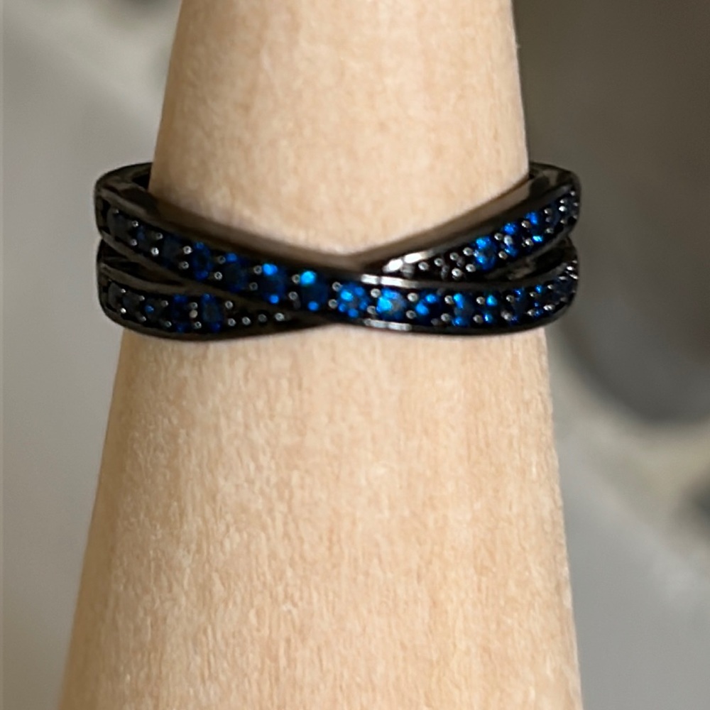 Ring in gunmetal color with tiny blue crystals. New.